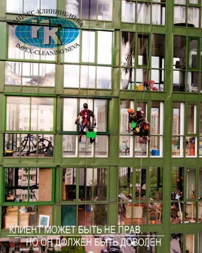 Очистка сплошного остекления жилого дома альпинистами весной